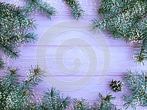 Christmas tree branch snow winter on a pink wooden background frame