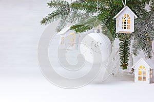 Christmas tree branch, wooden decorative toy houses garland and glass balls
