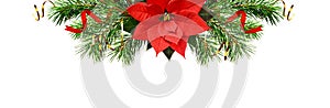 Christmas tree branches, bells and red poinsettia flower in a holiday header arrangement isolated on white background