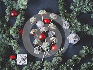 Christmas tree branches with cake pops and baubles