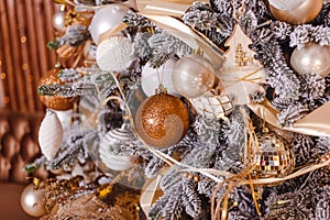 Christmas tree branches decorated with golden balls. Christmas decor and garlands