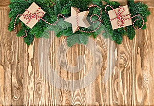 Christmas tree branches gift boxes wooden background