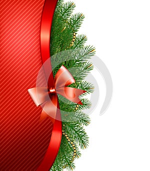 Christmas tree branches with a red ribbon and a bow photo