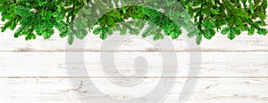 Christmas tree branches on wooden background banner