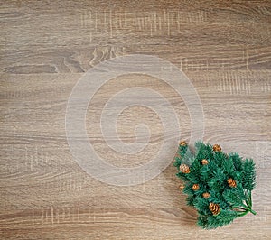 Christmas tree on brown wooden texture background.