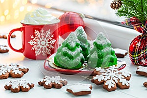 Christmas tree cakes, Christmas cookies and a Christmas mug on the windowsill