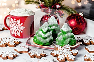 Christmas tree cakes, Christmas cookies and a Christmas mug on the windowsill