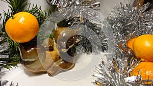Christmas tree celebration, cheerful bear with tangerine