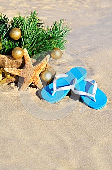 Christmas tree with christmas balls, slippers and starfish on th