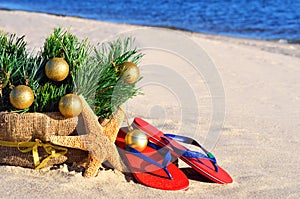 Christmas tree with christmas balls, slippers and starfish on th