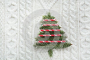 Christmas tree. Christmas concept with spruce, fir-tree, snowflakes on white knitted background. Holiday card. Vintage style.