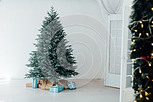 Christmas tree Christmas decoration interior of the white room with postcard gifts