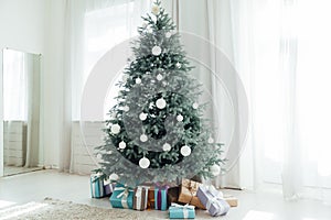 Christmas tree Christmas decoration interior of the white room with postcard gifts