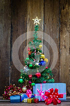 Christmas tree with colorful ornaments a wood background