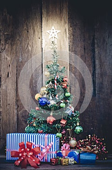 Christmas tree with colorful ornaments a wood background