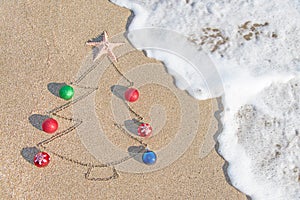 Christmas tree contour with decorations, star and wave on the beach