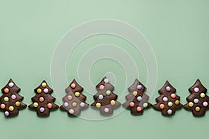 Christmas tree cookies with colorful candies in a row