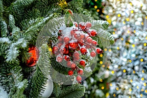 Christmas tree covered with snow. Xmas tree toys, balls and garland. Close-up