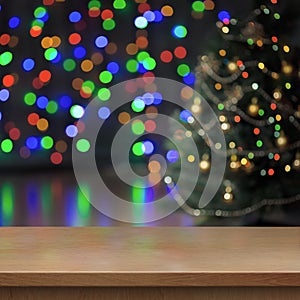 Christmas tree decorated behind empty wood table or shelf