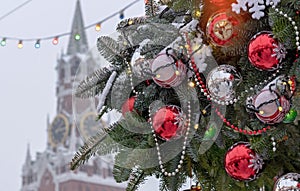 Christmas tree decorated with Christmas balls, snowflakes and garlands against the backdrop of the Spasskaya tower of the Moscow