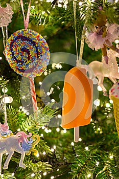 Christmas tree decorated is festivily decorated with vintage colorful balls, garlands and toys