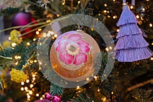 Christmas tree decorated is festivily decorated with vintage colorful balls, garlands and toys close up, Christmas background