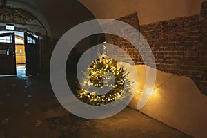 Christmas tree decorated with garlands in an ancient tunnel