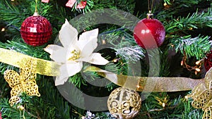 Christmas tree decorated with gold and red ornaments and blinking lights