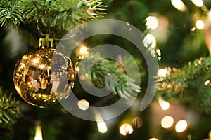 Christmas tree decorated with golden shiny baubles