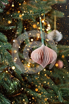 Christmas tree decorated with handmade eco paper ball, closeup view