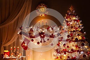 Christmas tree decorated with Lights in Fireplace Room with Candles, Red Stocking, Wreath and Clock on Wall. Shining White Xmas