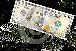 Christmas tree decorated with money. Dollar banknotes as Christmas tree toy. Rich year concept. Best gift for Christmas. Happy new
