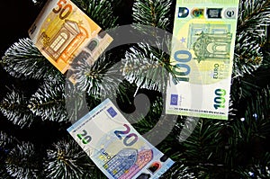 Christmas tree decorated with money. Euro banknotes as Christmas tree toy. Rich year concept. Best gift for Christmas. Happy new