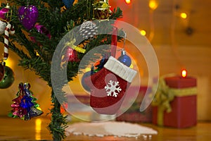 Christmas tree decorated with red glove and Pinecones on a blurred background