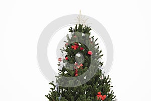 Christmas tree decorated with red and silver bows and balls, gold star isolated on white background