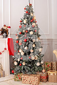 Christmas  tree decorated with toys, balls and lights glowing garlands in living room. Beautiful decorated Christmas tree with gif