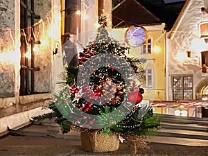 Christmas tree  decorated on  wooden  table top and street time  and  street time  in old town of Tallinn holiday in Estonia