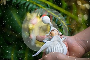 Christmas Tree Decoration Angel in Hands of Little Girl