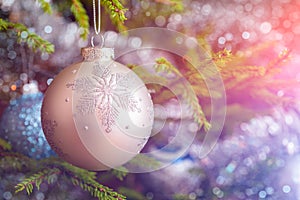 Christmas-tree decoration bauble on decorated Christmas tree bac