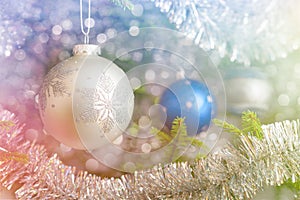 Christmas-tree decoration bauble on decorated Christmas tree bac