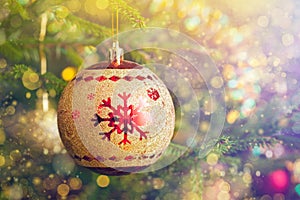Christmas-tree decoration bauble on decorated Christmas tree bac
