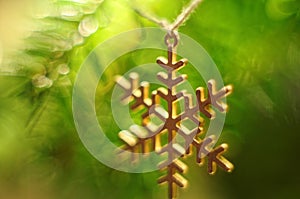 Christmas tree decoration. Snowflake hanging on twine. Bokeh background.Christmas tree twig.