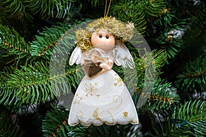 Christmas tree decoration white angel with shiny wings and Golden hair.