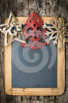 Christmas tree decorations border on vintage wooden blackboard