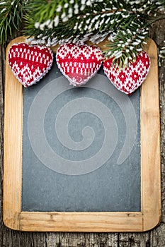 Christmas tree decorations border on vintage wooden blackboard