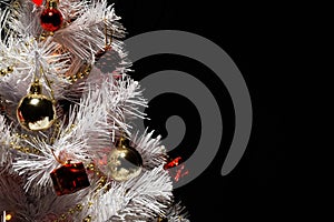 Christmas tree with decorations. Christmas tree on a dark background. Empty space for a logo.