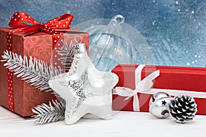 christmas tree decorations and gift boxes against blue background