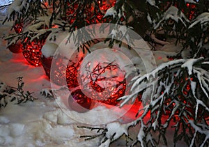 Christmas tree decorations in the snow under the Christmas tree
