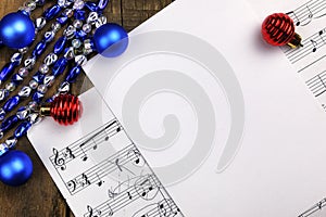 Christmas tree decorations on the table and sheet with music not