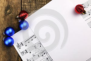 Christmas tree decorations on the table and sheet with music notes